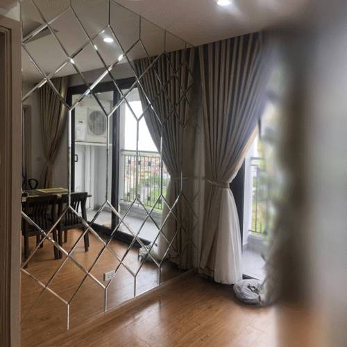 bevelled mirror tiles fitted as a decorative feature wall panel