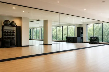 Full wall commercial mirrors installed in a gym or studio