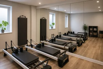 Small reformer Pilates studio with fitted wall mirrors